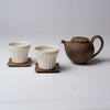 Yuko Matsuzuka, Cup with longitudinal flutes, cream glaze flecked with ochre and teapot