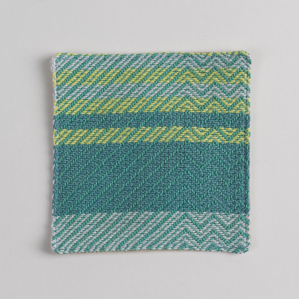 Hand woven cotton coaster - emerald green, front